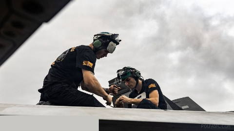 U.S. Navy sailors carrying out maintenance and repairs on F/A-18E Super Hornet fighters on the flight deck…