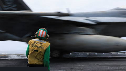 US Navy sailors monitoring the launch of F/A-18E Super Hornet fighters from the aircraft carrier USS George H.W. Bush…